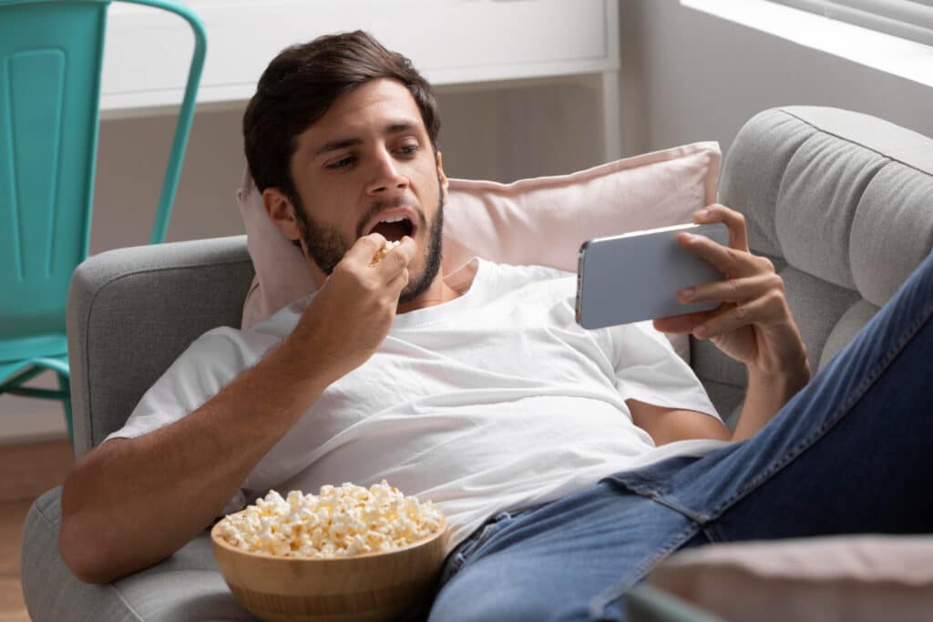 man watching streaming service his phone